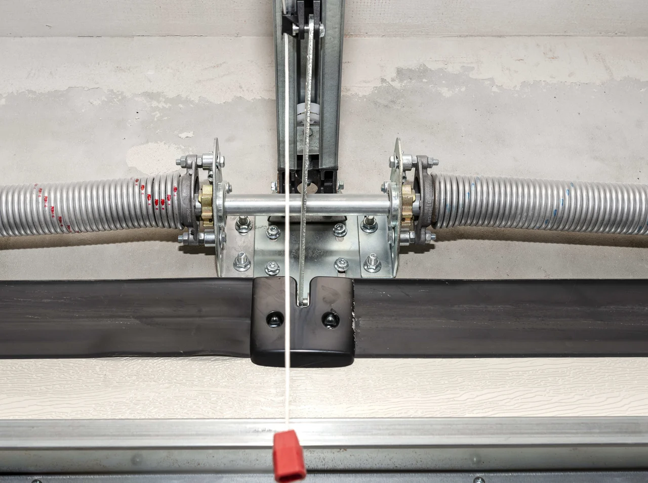 Technician checking garage door balance and force settings