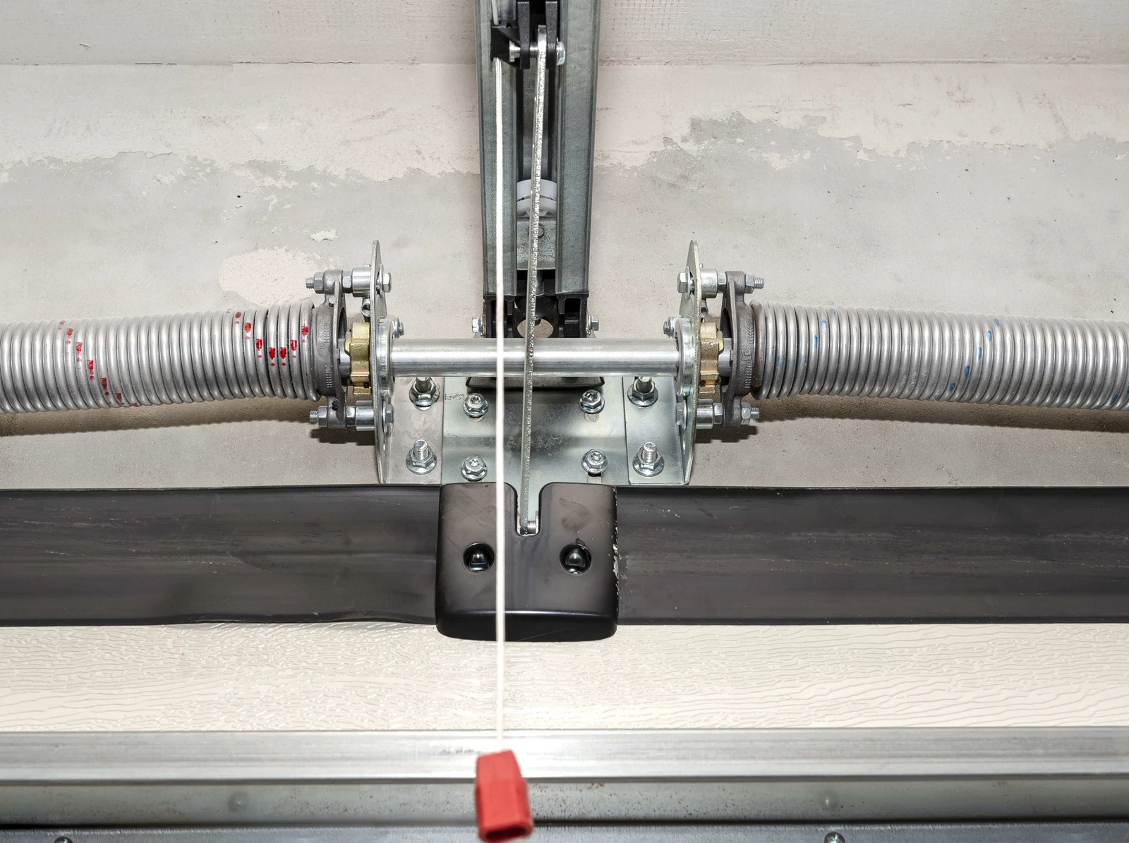 Garage door springs and center bracket carrying a sectional door