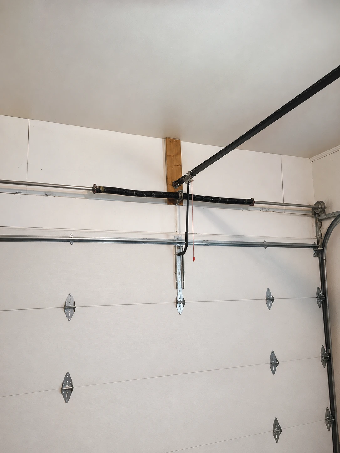 Worn garage door spring system before replacement