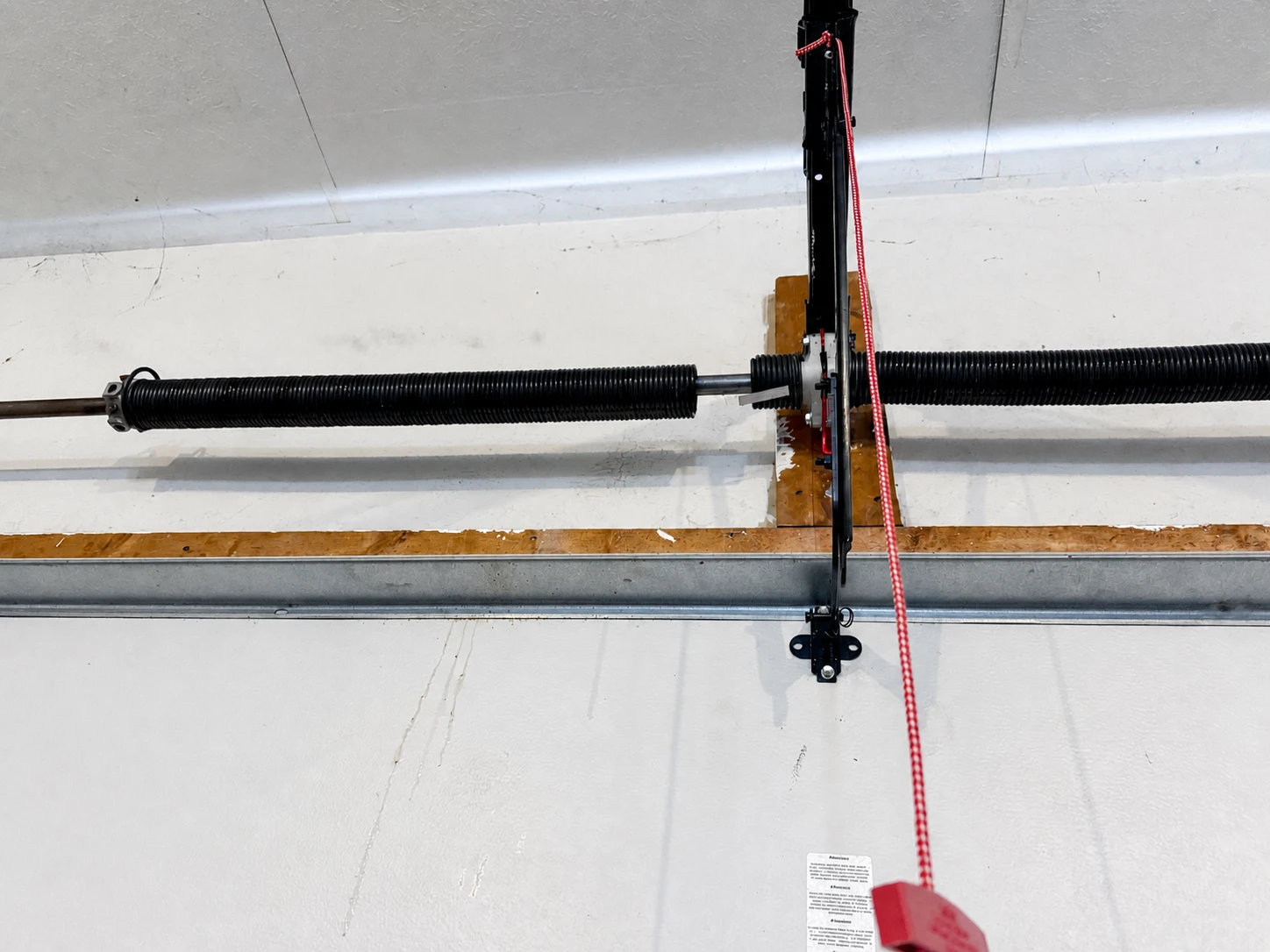 Visible separation in a broken torsion spring above a garage door