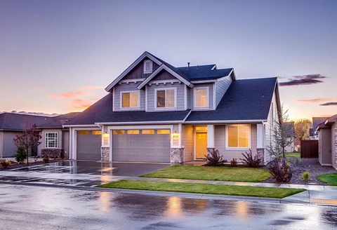 Beautiful residential home with professionally installed new garage doors showing complete installation services including modern sectional doors, hardware, and finished curb appeal in Louisville, KY