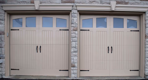 Professional garage door repair technician working on broken springs, cables, and rollers in Louisville, KY showing expert repair service