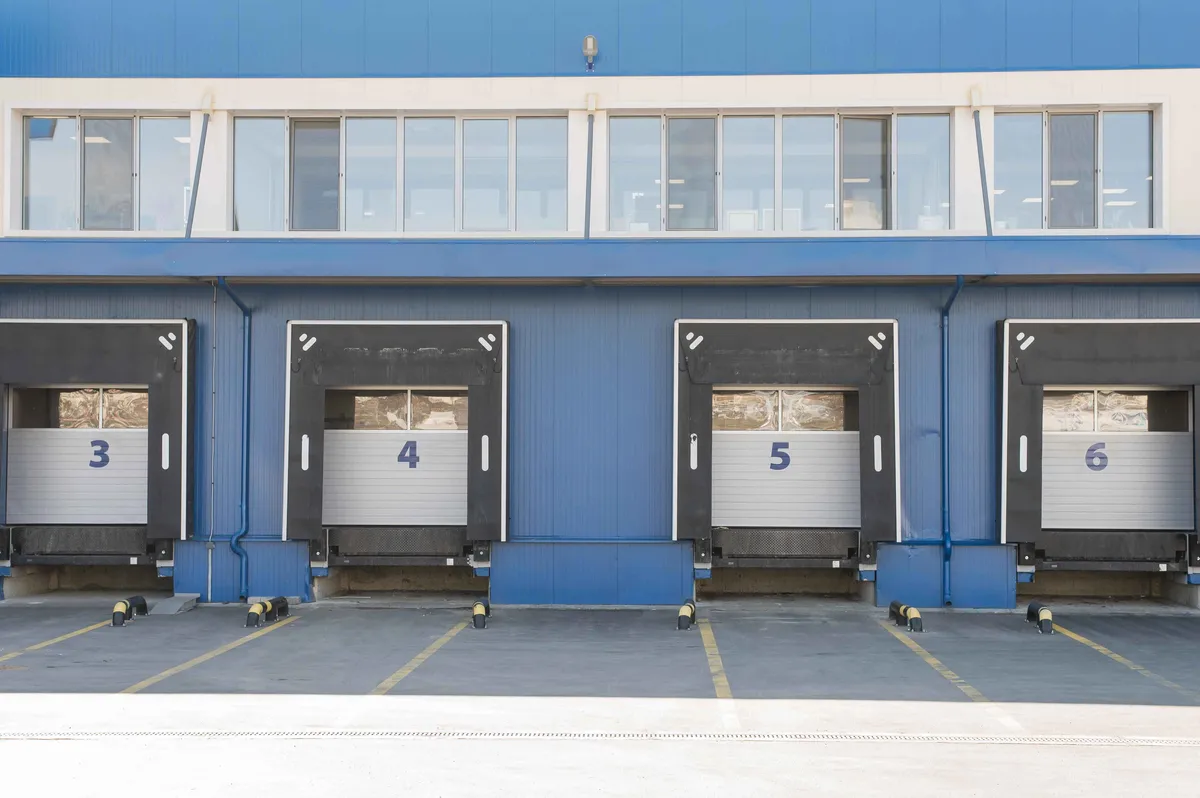 Smart-enabled commercial garage doors in a Kentucky logistics facility monitored for uptime reliability.