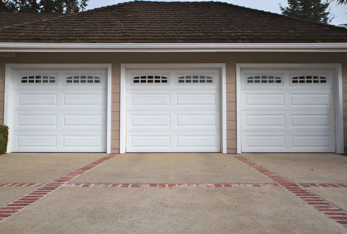 Professional performing a comprehensive garage door tune-up