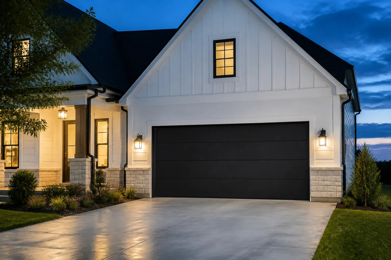 Modern black flush garage door on a white Kentucky home at dusk