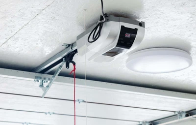 Quiet belt-drive garage door opener mounted on ceiling rail in residential garage