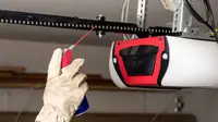 Professional chain-drive garage door opener installation showing durable metal chain mechanism and motor system for reliable heavy-duty operation in Louisville residential garages