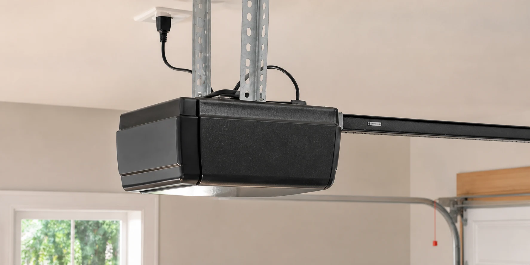 Ceiling-mounted garage door opener, rail, and drive arm