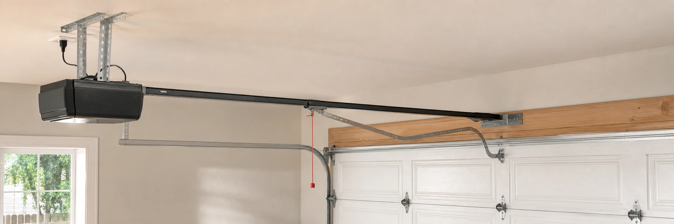 New ceiling-mounted opener and rail installed above a sectional door