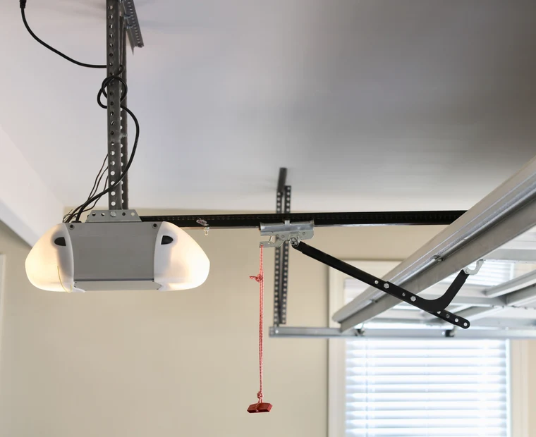 Garage door opener unit mounted to a garage ceiling
