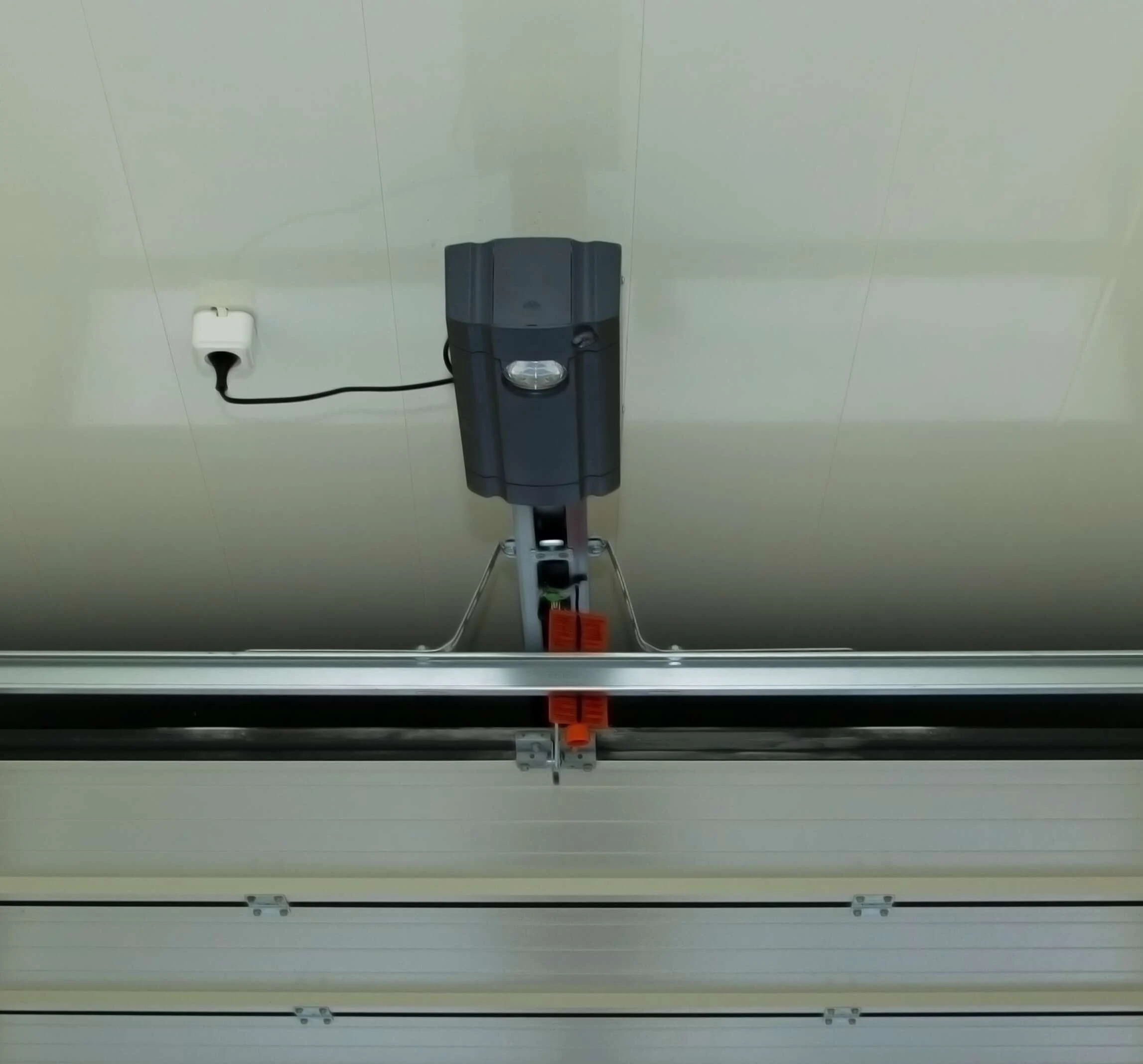 Legacy screw-drive garage door opener mounted above a garage door
