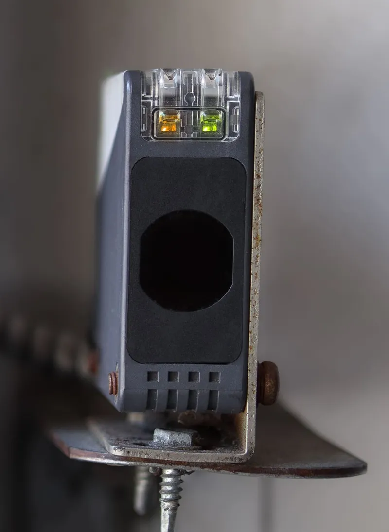 Garage door safety sensor repair and alignment near floor track