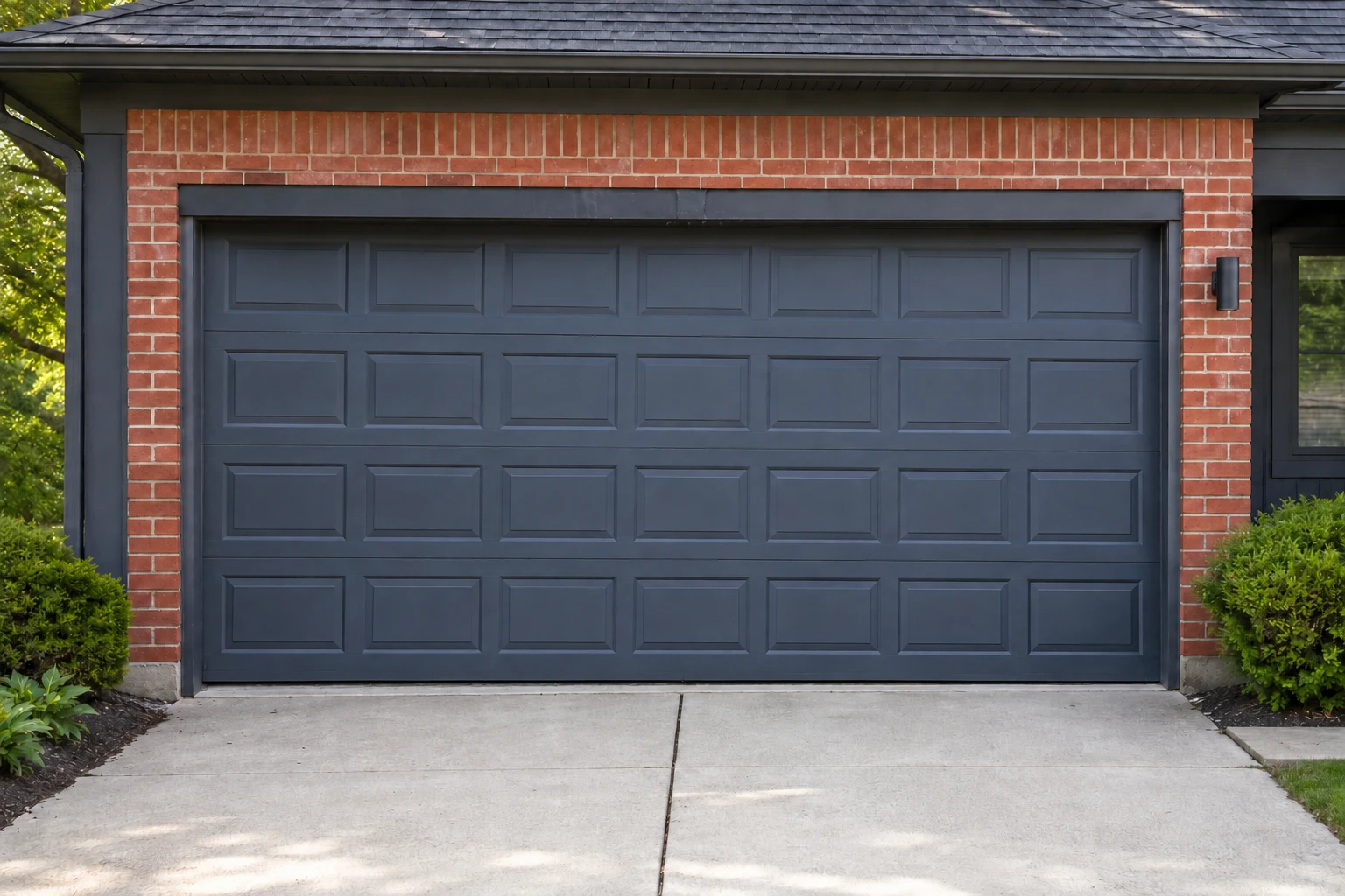 Dark gray garage door level and secured in its tracks after repair