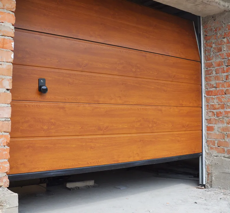 Garage door track alignment and hardware correction by technician