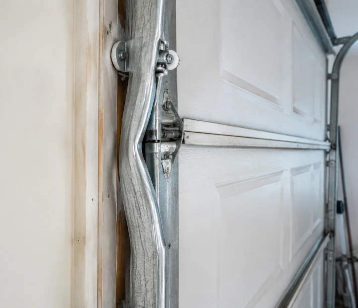 Close-up inspection of garage door track and section hardware
